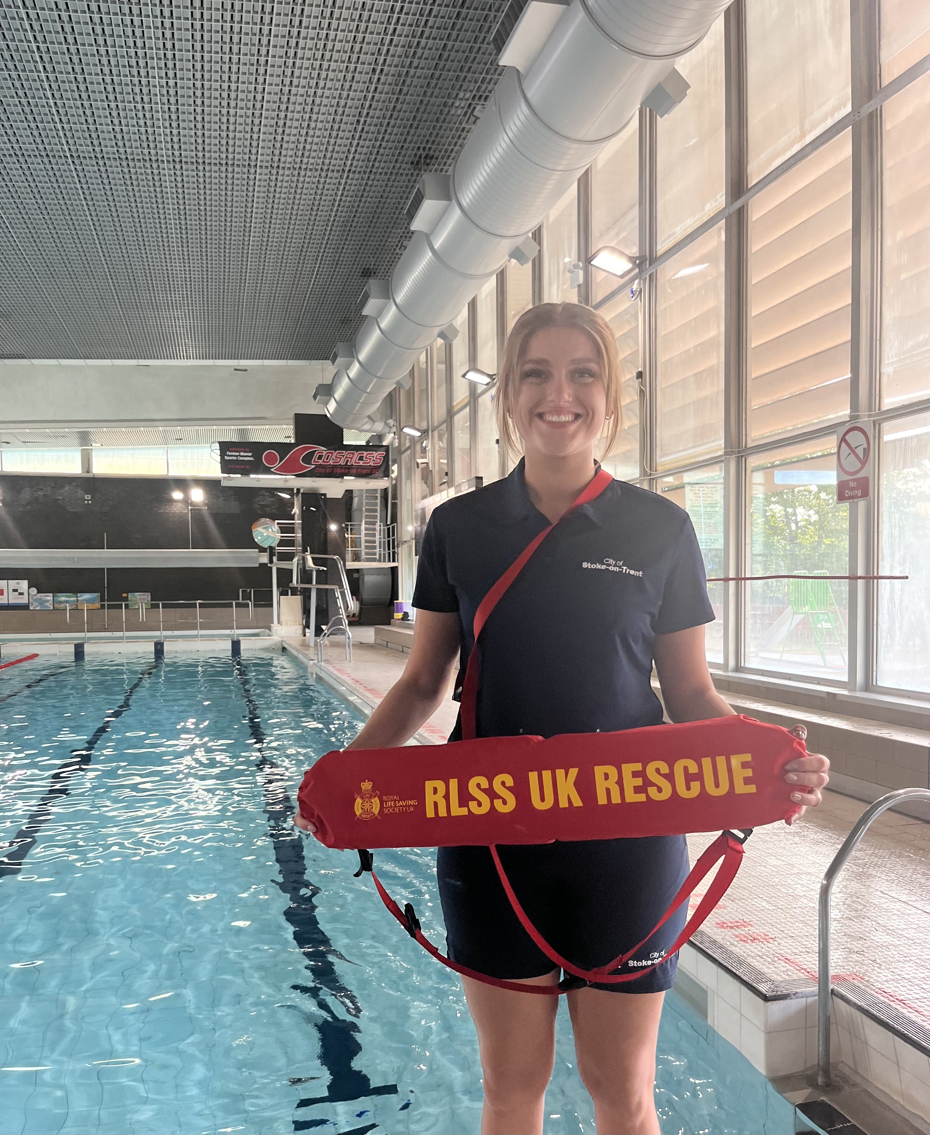 Image showing a lifeguard standing next to a swimming pool