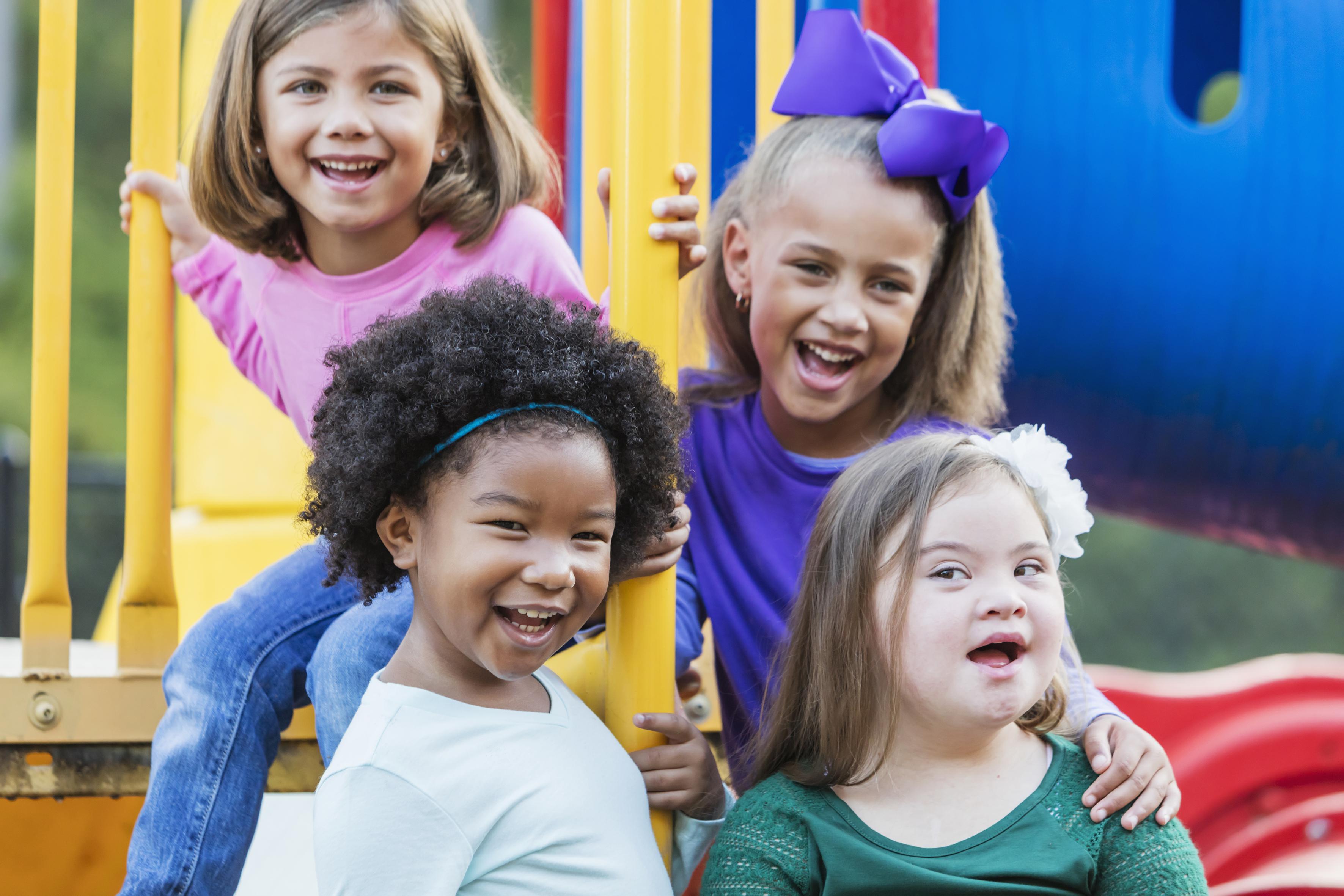 a group of children sitting at a playground together